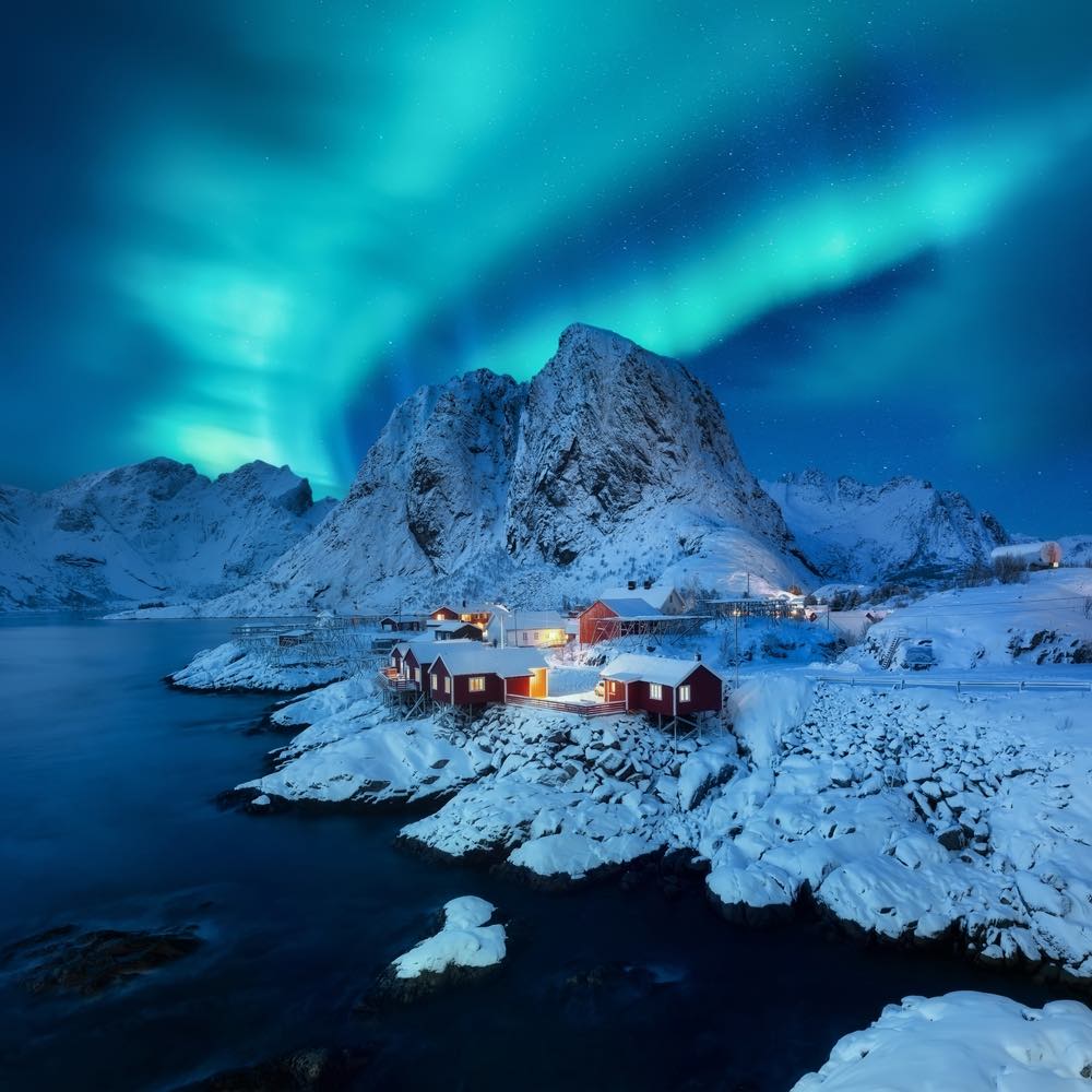 The aurora borealis over a small settlement in the Lofoten Islands, Norway.