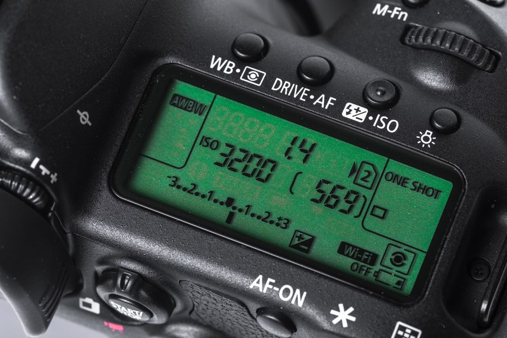 A close-up view of the top LCD screen of a modern DSLR camera, showcasing a high ISO setting of 3200. High ISO digital photography.