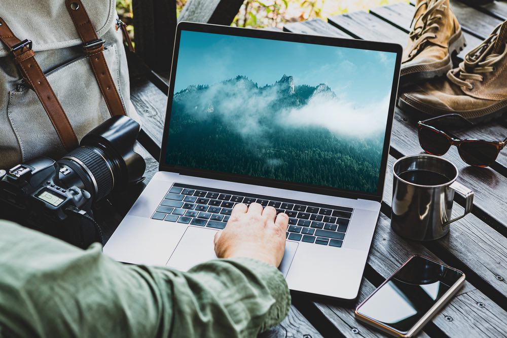 Edit landscape photos on your laptop using Adobe Lightroom.