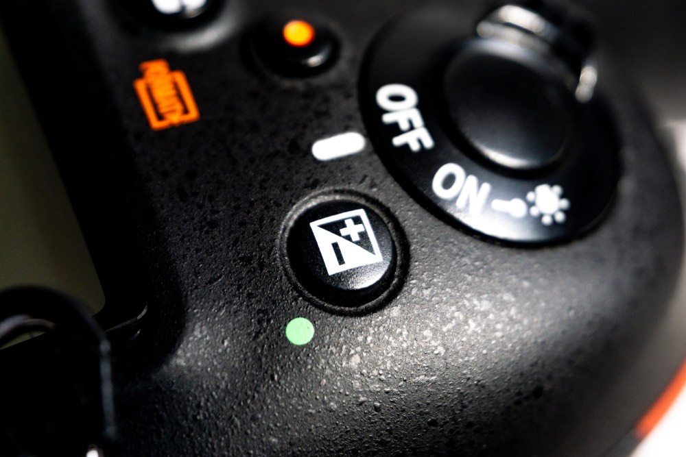 Close-up view of the exposure comp. button on a contemporary DSLR camera. Exposure compensation is an essential tool for getting well-lit and properly exposed images.