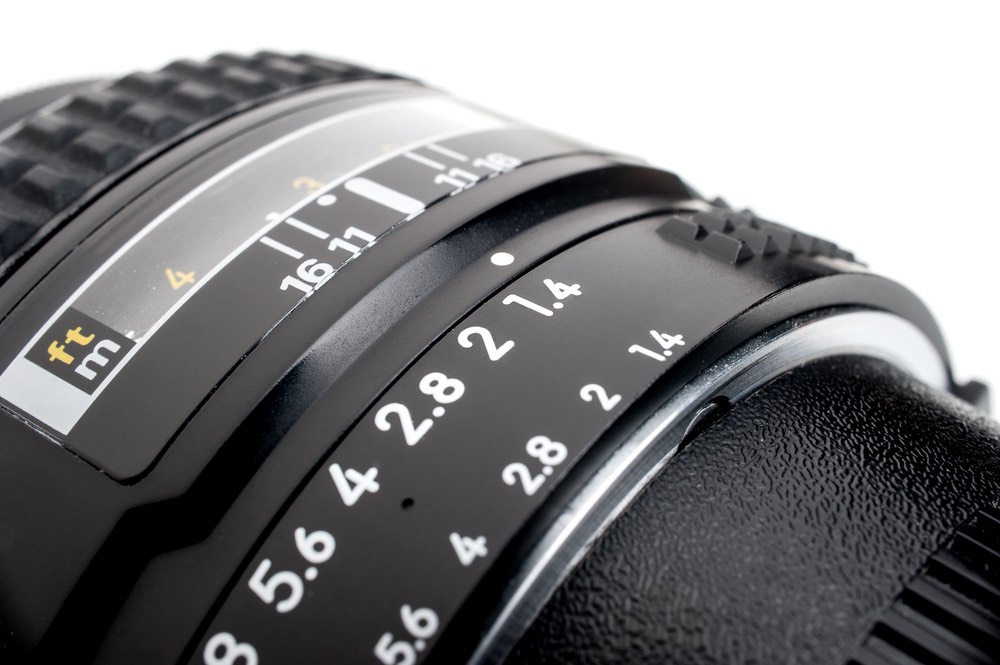 A close-up view of a camera lens showcasing its aperture scale, going up to f/1.4. An example of a lens with a fast maximum aperture.