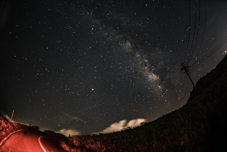 To get the best star photographs, you have to get away from light pollution to areas where the sky is the darkest, such as seen along this isolated road.