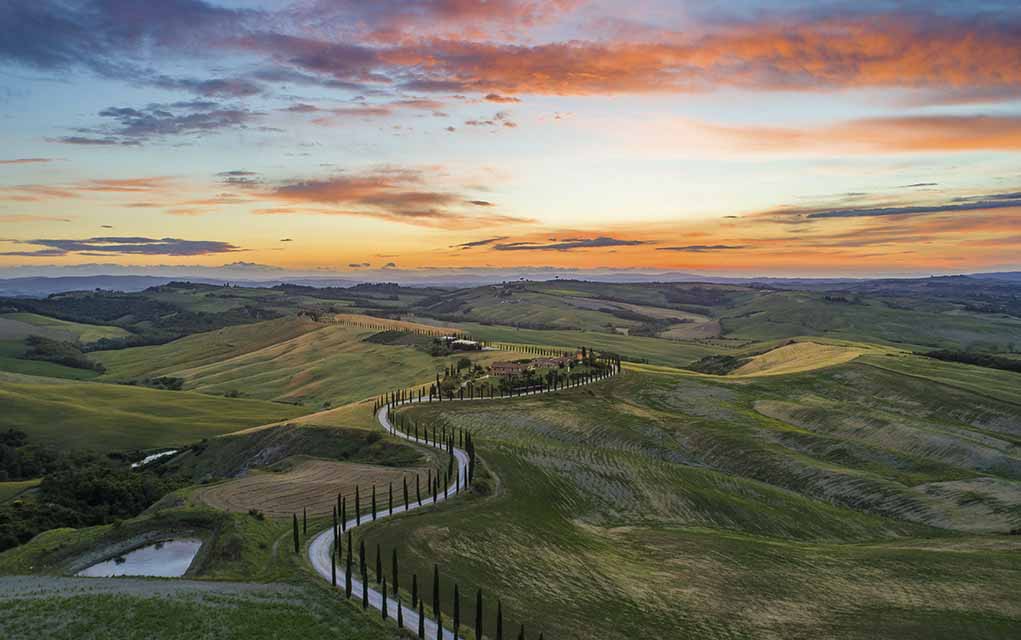high quality landscape photo winding road and sunset.