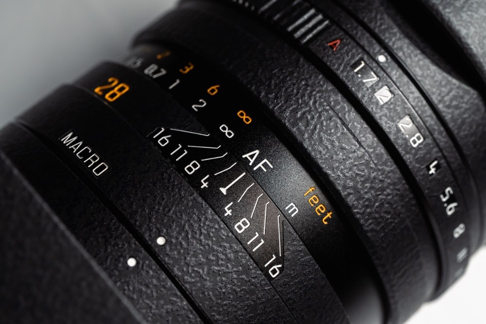 Close-up view of a modern Leica camera lens displaying its depth of field (DOF) scale and focus ring numbers.