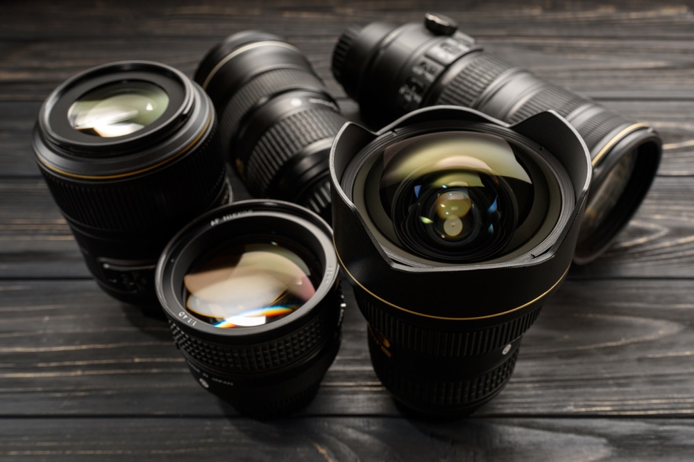 A collection of DSLR lenses of different focal lengths, showcasing the differences between telephotos and wide-angle lenses.