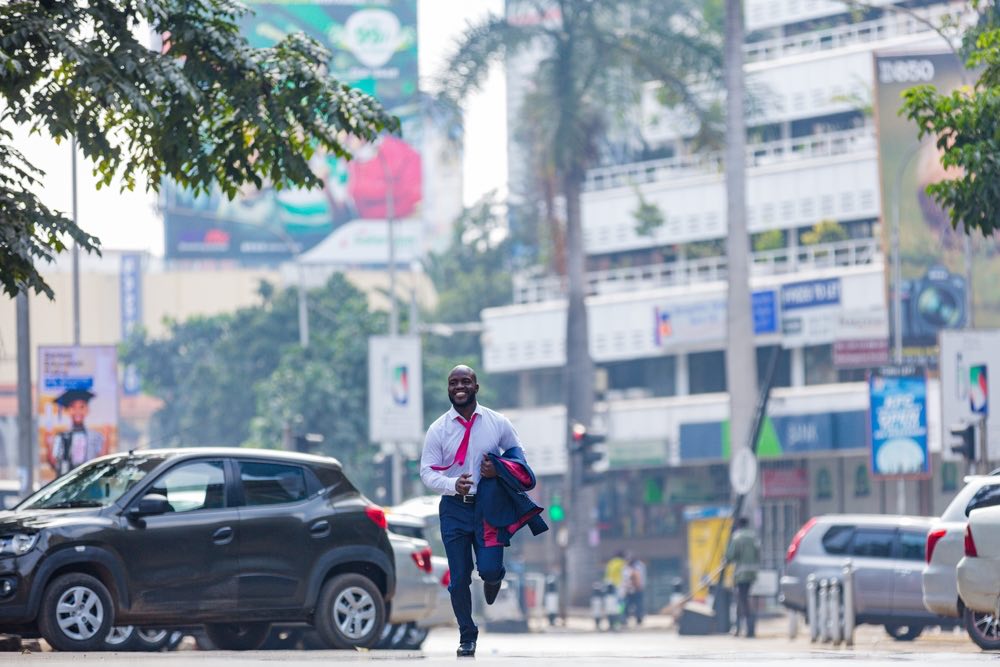 A man running down the street during the day in Nairobi, the capital of Kenya. An example of a candid scene caught on camera which may be called a 'decisive moment'.