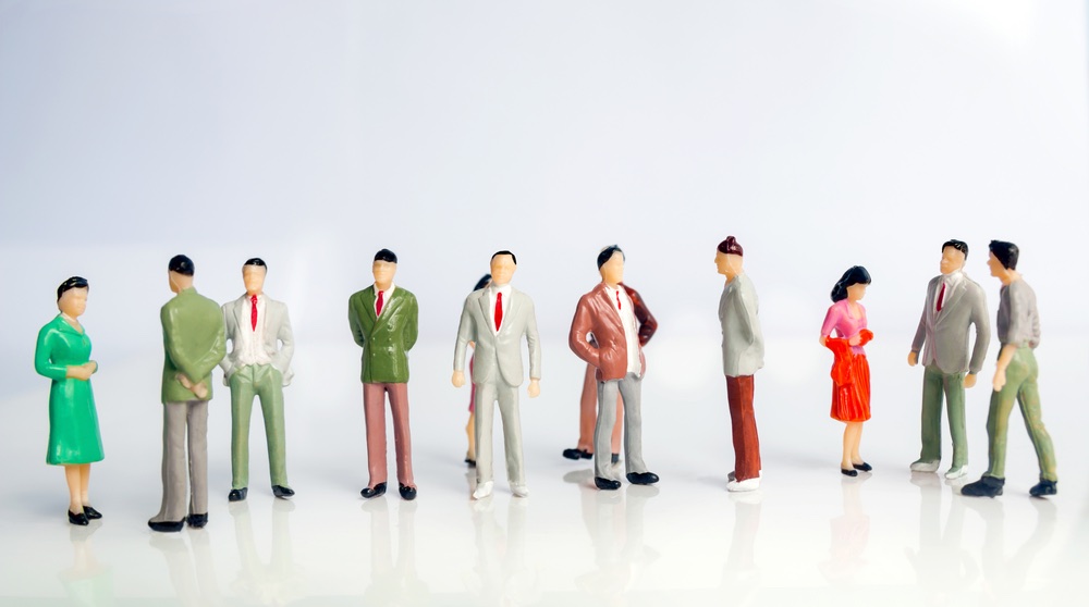 A set of miniature figurines patterned after adult businesspeople. An example of using figurines in miniature photography to create a scene.
