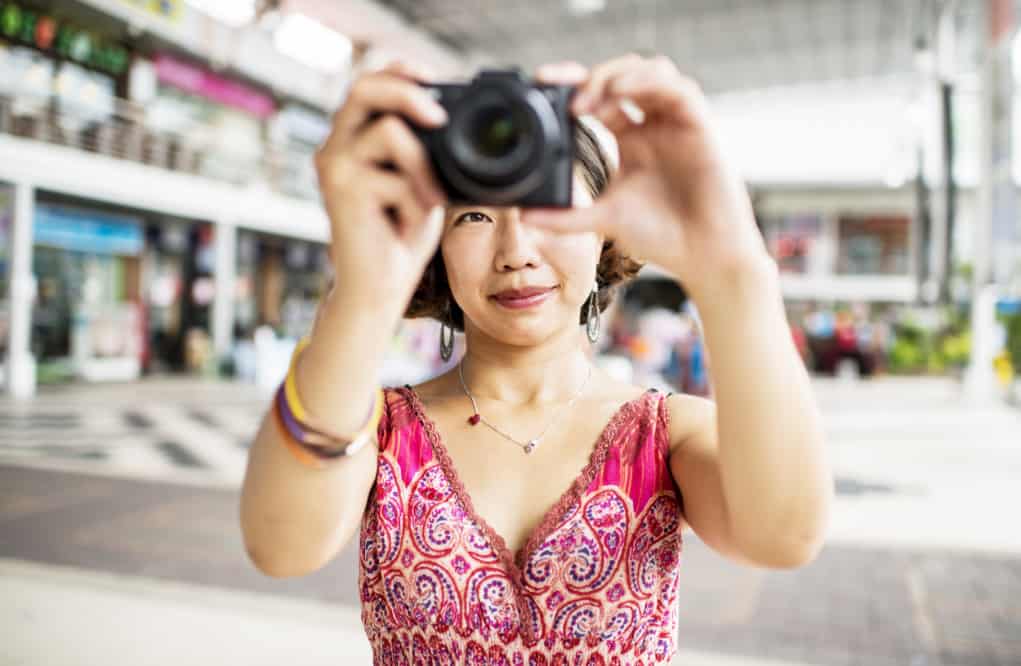 Woman taking a photo using dslr.