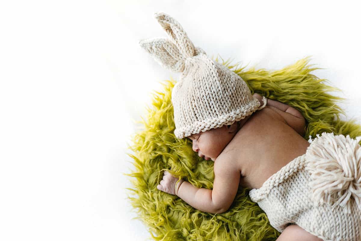 baby wearing a rabbit costume.