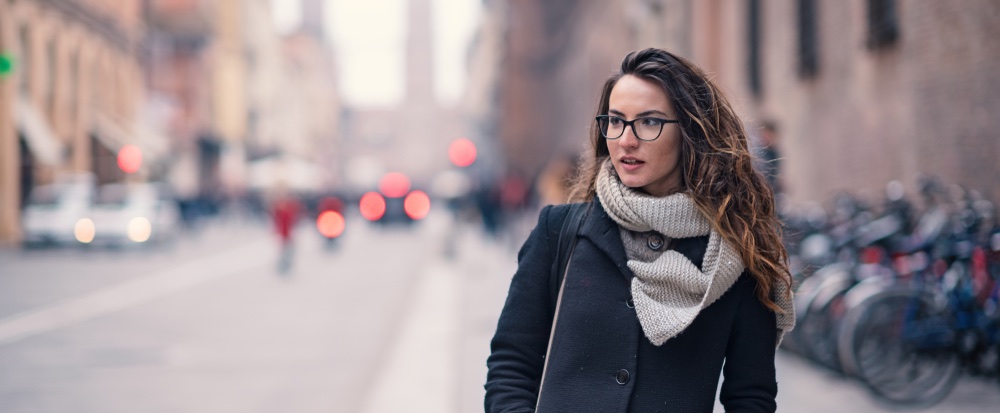 focused portrait of a women on the street with background blur.