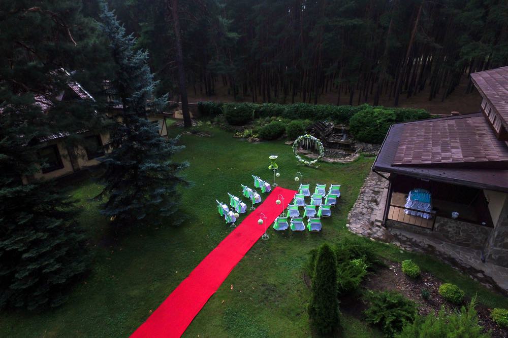 An aerial shot of an outdoor wedding ceremony.