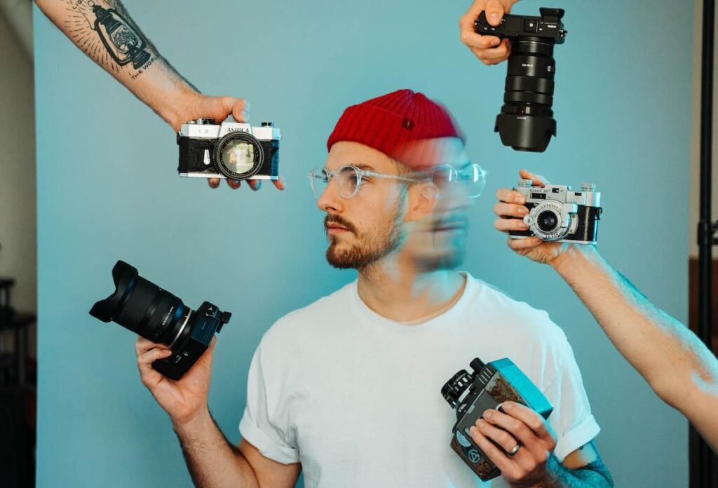 conceptual photo of photographer deciding between camera equipment.
