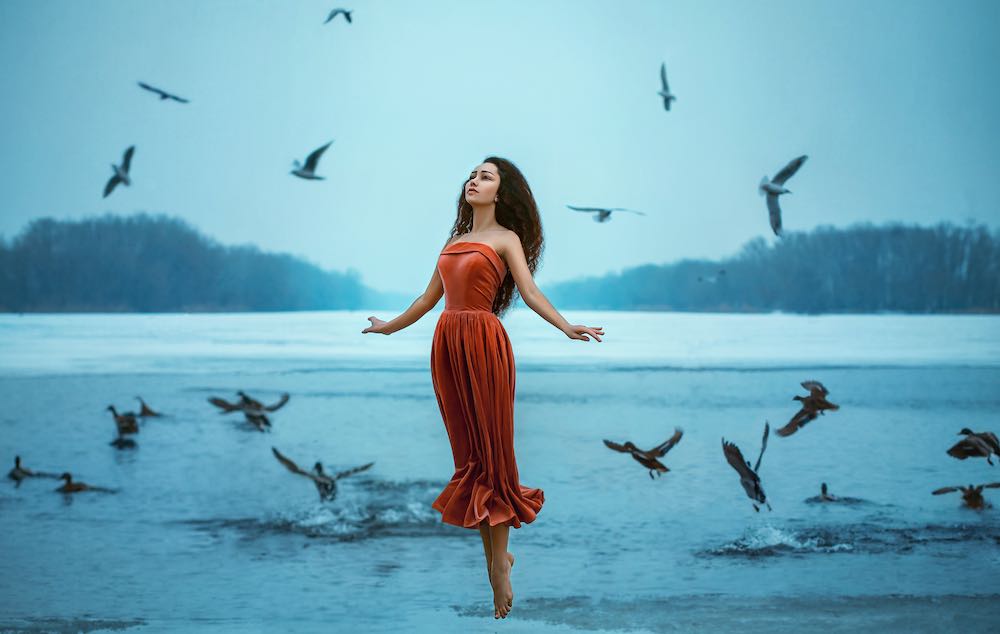 levitation shot of woman on a lake.