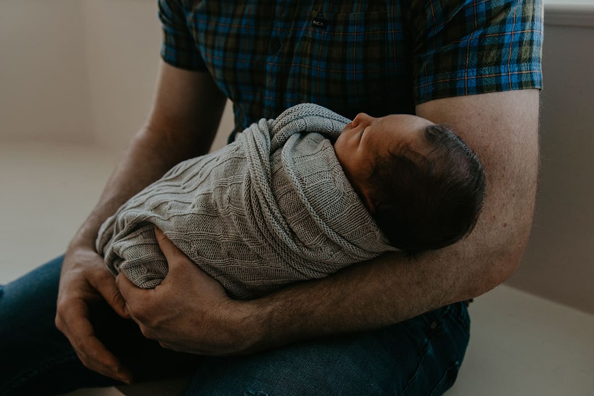 baby in father's arms.