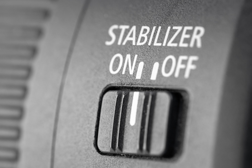 Close-up view of the stabilizer switch on a modern DSLR lens.