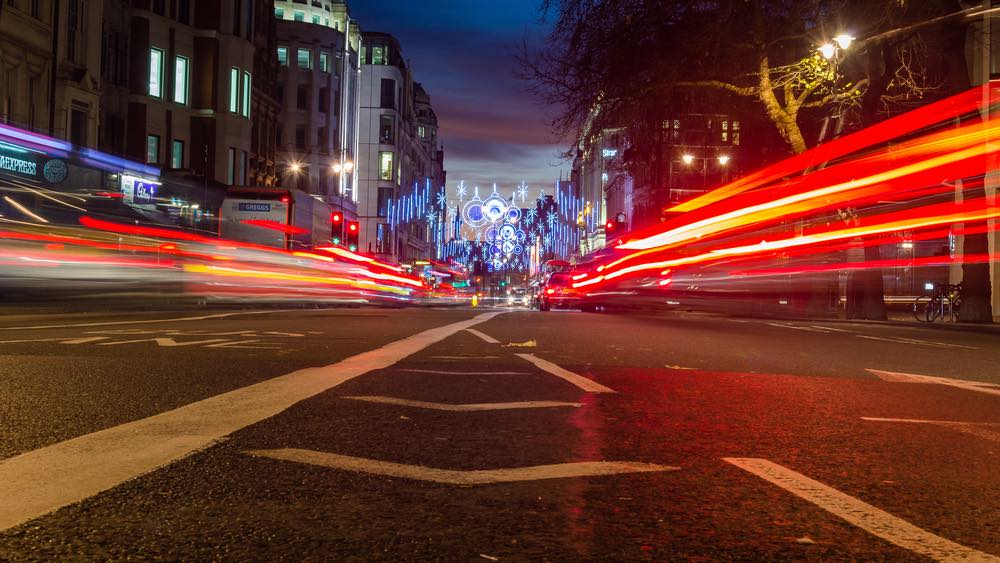 Night photography using light trails from passing traffic. Low-angle photography at night in color.