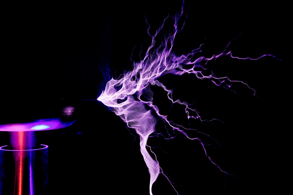 A wave-like discharge of visible electrical current emanating from a classic tesla coil. An example of corona discharge, a crucial element of Kirlian photography.
